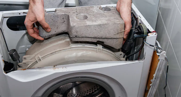 handyman-repairing-a-washing-machine-the-hands- handyman-repairing-a-washing-machine-the-hands-