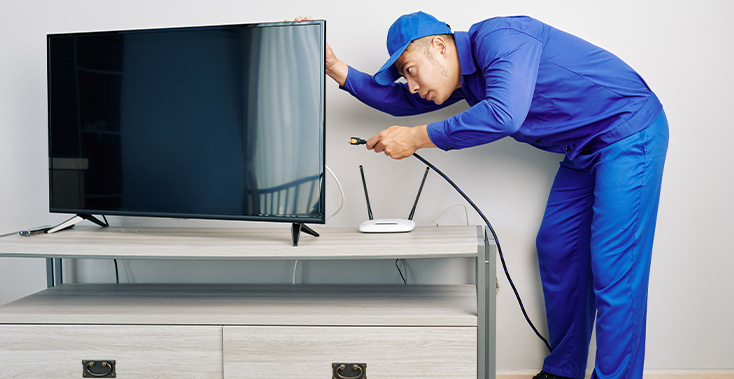 repairman-installing-tv-set
